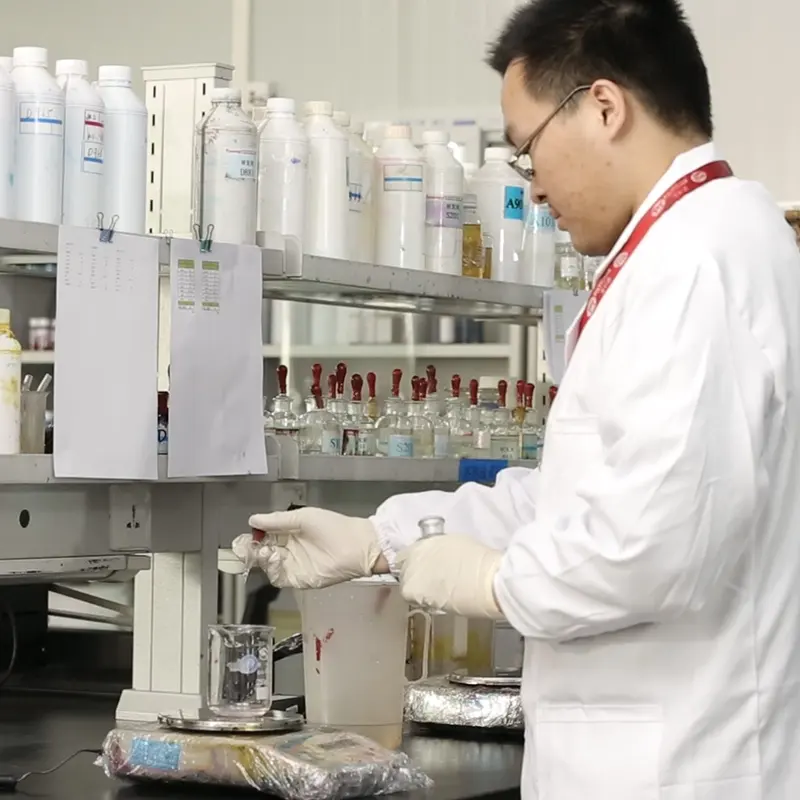 Laboratory setup for pigment ink preparation showing beakers, mixers and testing equipment